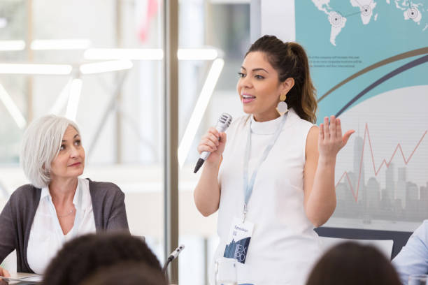 Expo speaker shares issues affecting Hispanic women While the moderator looks on, a mid adult woman shares her experience with the issues affecting Hispanic women across the globe. keynote speech stock pictures, royalty-free photos & images