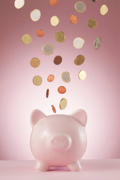 Piggy Bank with falling euro cents in front of a pink background