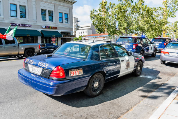 Saint John, New Brunswick, Canada - November 26, 2017: A police car with its red and blue lights on travels at high speed down the center of a city street.