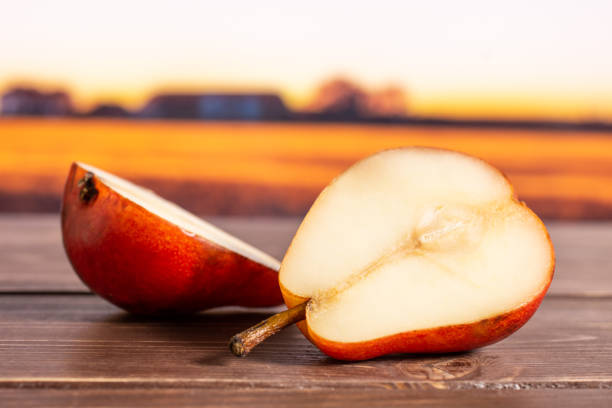 istock Fresh red pear with autumn field behind 1147622499