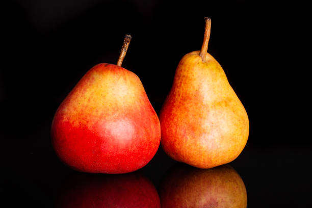istock Fresh red pear isolated on black glass 1147622519