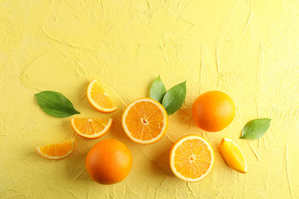 istock Flat lay composition with ripe oranges and leaves on color background. Top view, space for text 1147626820
