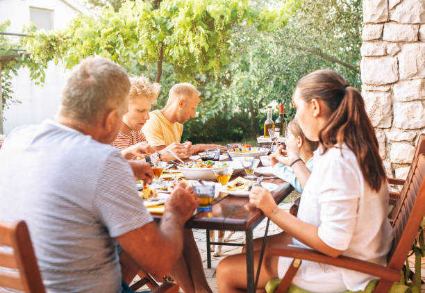 istock Big multigeneration family have dinner on open garden terrace 1147629003