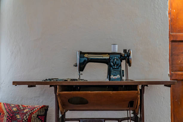 istock Classic vintage style manual sewing machine on wooden table 1147630395