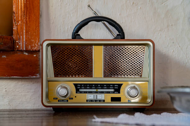 Retro broadcast radio receiver on wooden table stock photo