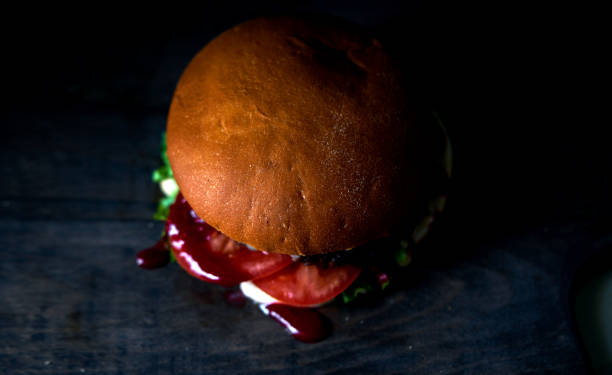 istock juicy Burger on black background 1147631856