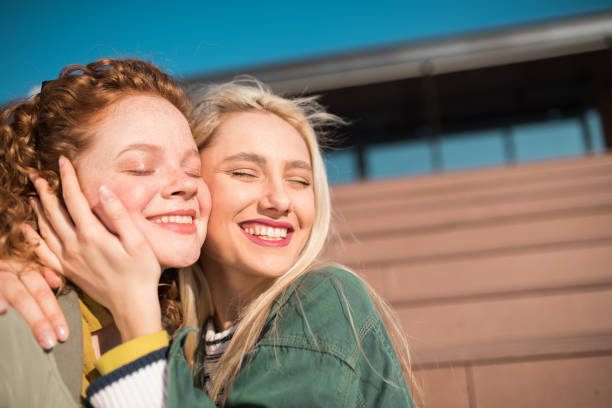 istock Girls hugging and smiling 1147634885