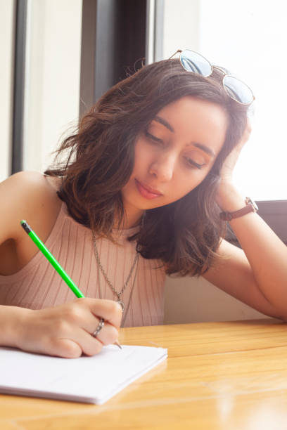 istock working young women writing something on paper 1147635621