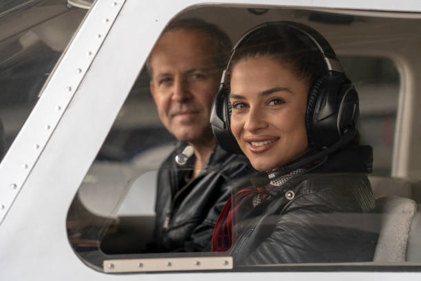 istock Smiling Female Pilot and Flight Instructor in an Aircraft Cockpit 1147636014