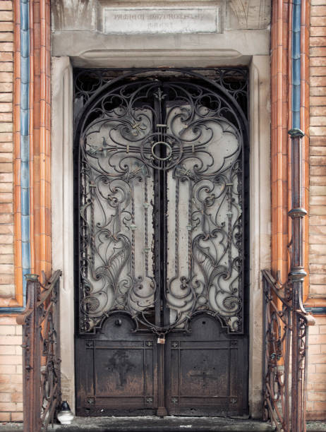 istock Closed forged gate. The old destroyed church. (concept death) 1147636032