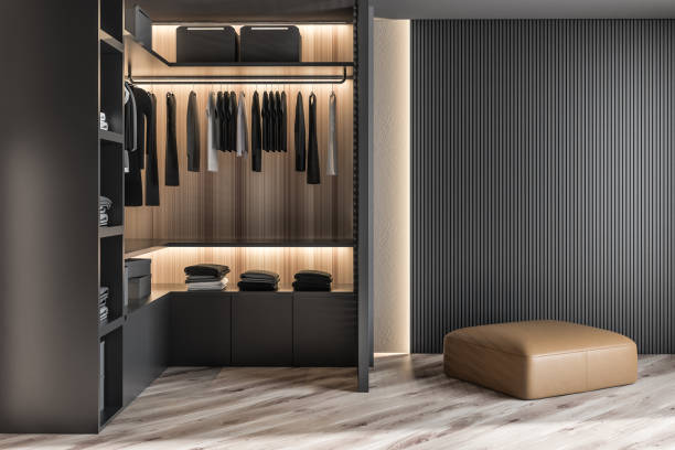 Modern wooden wardrobe with clothes hanging on rail in walk in closet design interior. 3D render Modern wooden wardrobe with clothes hanging on rail in walk in closet design interior. 3D render cloakroom stock pictures, royalty-free photos & images