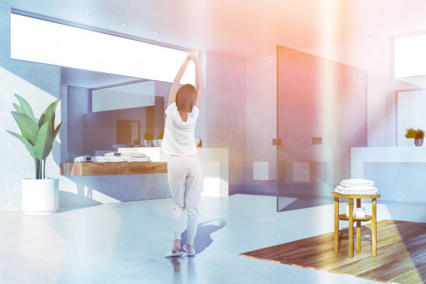 istock Woman in white bathroom with sink 1147637060