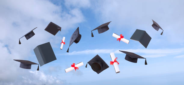 istock hands raised and hats and diplomas 1147637273