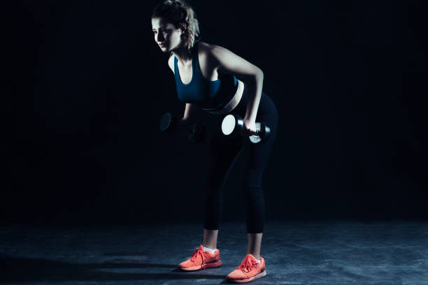 istock Fitness woman on black background 1147638485