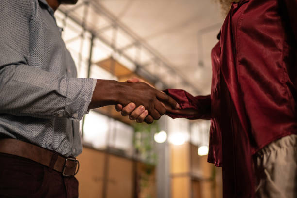 istock Shaking hands in meeting at night office 1147639546