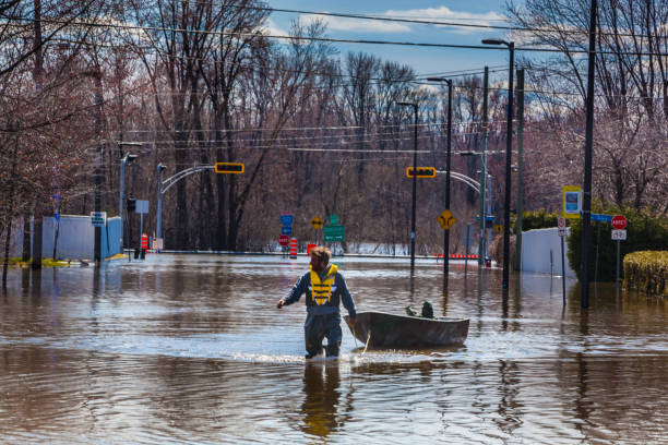 Gatineau, Canada - Avril 30, 2019: This is the big flood of the city of Gatineau, Quebec, Canada. This is the Gatineau River flooding the Boulevard de la Gappe. You can see a man with his boat.