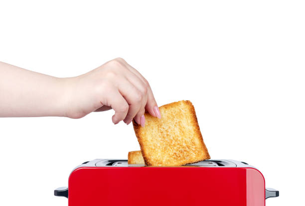 istock Red toaster with toasted bread. Hands girl pulls out ready toasts. Isolated on white background. File contains a path to isolation. 1147642454