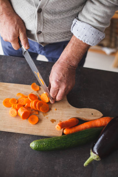 istock Man preparing fresh vegetables for salad 1147655757