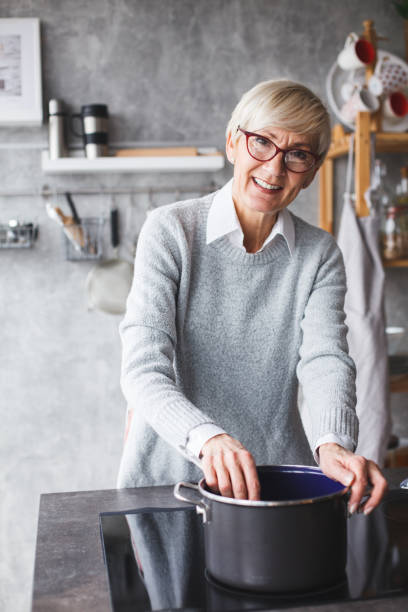 istock Senior woman preparing lunch 1147655764