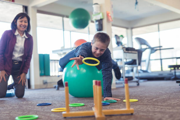 istock A boy does workouts with an occupational therapist at a physiotherapy clinic 1147656575