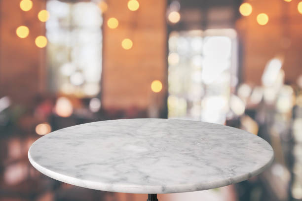 round marble table top with cafe restaurant bokeh lights abstract background for montage product display