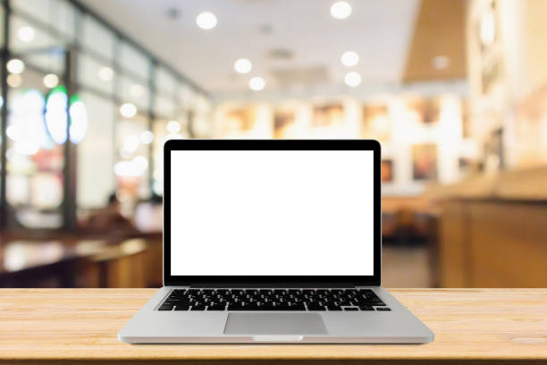 istock Blank screen laptop computer on wood table top with blur cafe restaurant with abstract bokeh light defocused background 1147656656