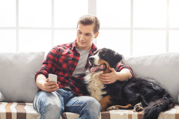 Young person with dog at home leisure