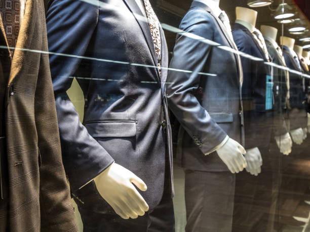 men suits, with shirts, ties, pants and blue jackets on display on dummies in front of a tailor store, on a window. it is one of the main formal garments in male fashion - fashion men fashion model male imagens e fotografias de stock