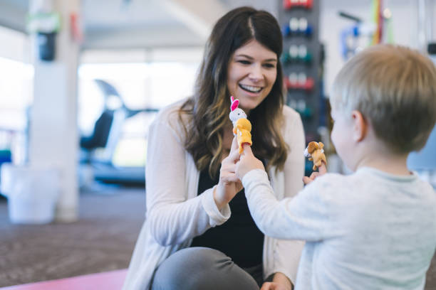 istock Physical therapist working with a young boy in the clinic 1147664089