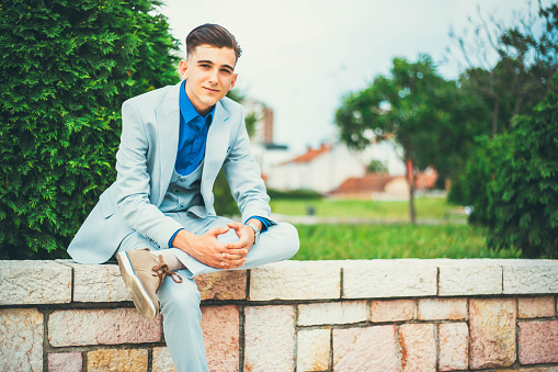 Portrait of teenage man sitting outdoor