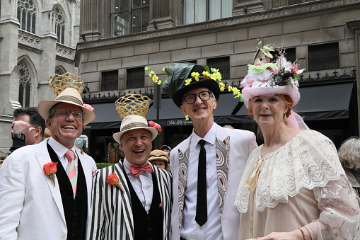 New York City, NY, USA- April 21, 2019: A group of participants in the annual Easter Bonnet Parade on Fifth Avenue, wearing similiarly themed costumes, pose for the crowd.