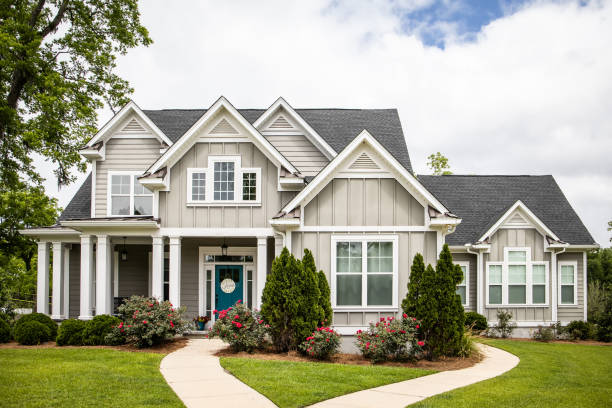 Single Family New Construction Home in Suburb Neighborhood in the South This is a single family home that is new construction cottage style house with hardy board and a partial metal roof. It is grey with a teal door and there is great curb appeal. The house has a double front entrance and it is on a large lot. facade stock pictures, royalty-free photos & images