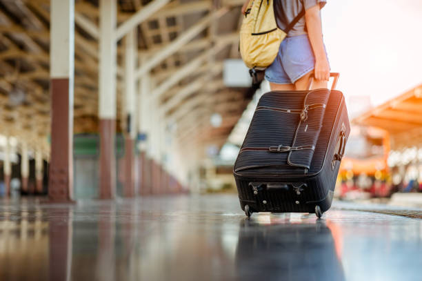 istock Travelling guy with his luggage while waiting for transport.Copy space 1147675124