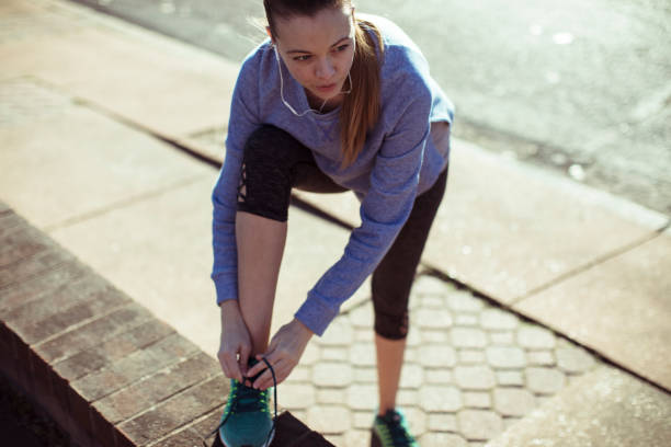 istock Woman Tying Shoelaces 1147675738