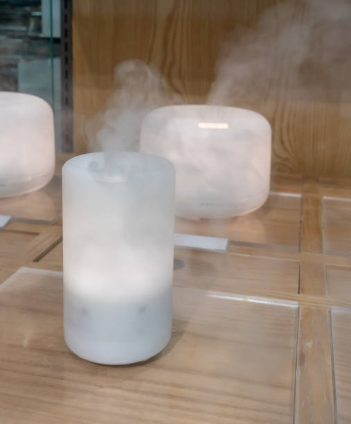 istock Electric aroma oil diffuser on wooden floor. Aroma sample 1147676737
