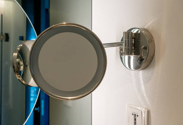 istock Circle shape mirror with LED light mount on white wall in restroom. Round mirror in the bathroom. 1147676752