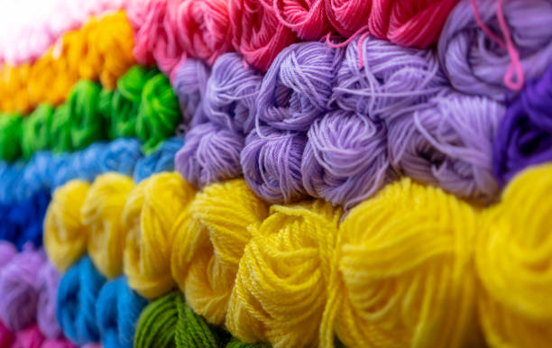 istock Colorful big thread in store. Colorful yarns for embroidering. Different color threads on rows in the store 1147676887