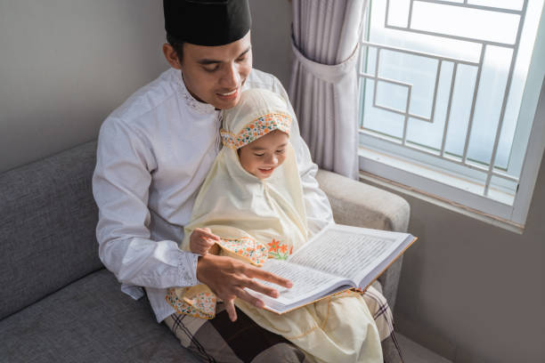 muslim father read quran with his daughter asian muslim father read quran with his daughter father allah stock pictures, royalty-free photos & images