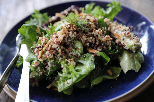 istock Quinoa salad with vegetable on wooden table 1147683604