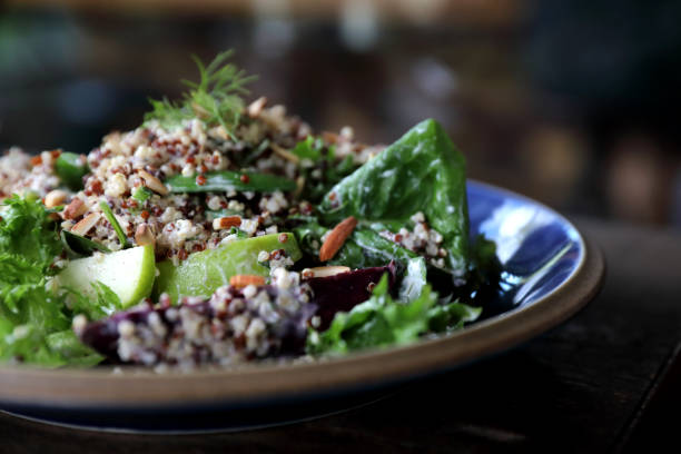 istock Quinoa salad with vegetable on wooden table 1147683613