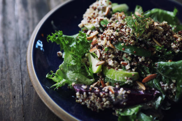 istock Quinoa salad with vegetable on wooden table 1147683620