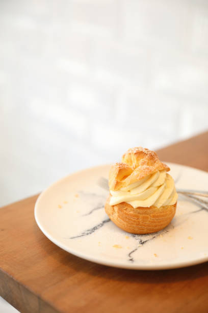 istock choux cream on wooden table 1147683694