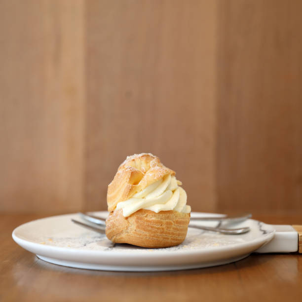 istock choux cream on wooden table 1147683712