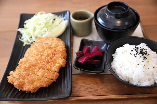 Tonkatsu fried pork cutlet with rice and soup on wooden table Japanese food