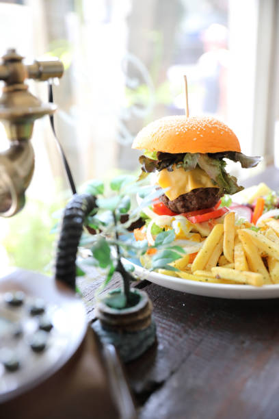 istock Beef hamburger fastfood on wooden table 1147684074