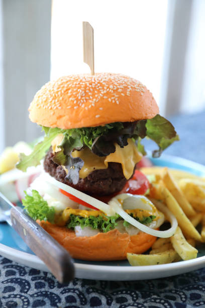 istock Beef hamburger fastfood on wooden table 1147684085