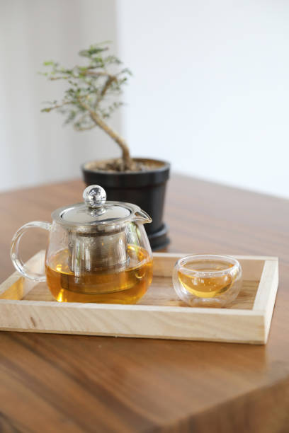 istock Hot teacup with teapot beverage on wooden table 1147684157