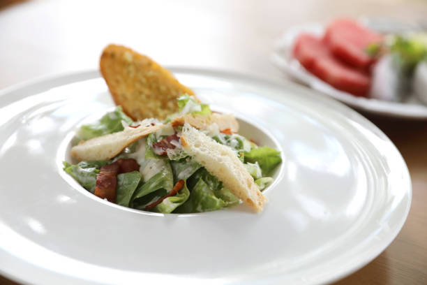 istock fresh salad with bacon and bread on wooden background 1147684202