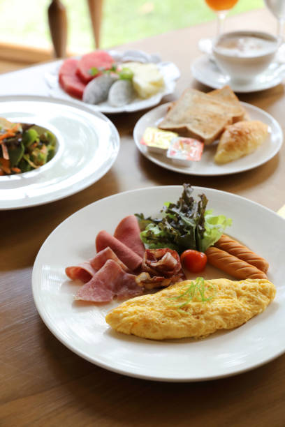 istock Breakfast set Omelette with sausage bacon and salad on wood background 1147684217