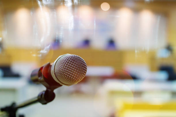 istock Close up of microphone on a podium in auditorium 1147684364
